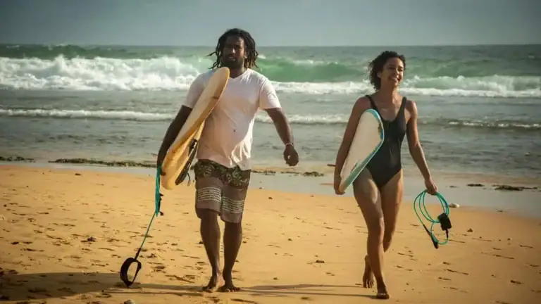 Surfers walking on a beach after surfing in Sri Lanka - Hikkaduwa