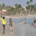 Foreign travellers enjoying a beach swim on Sri Lanka’s southern coast.
