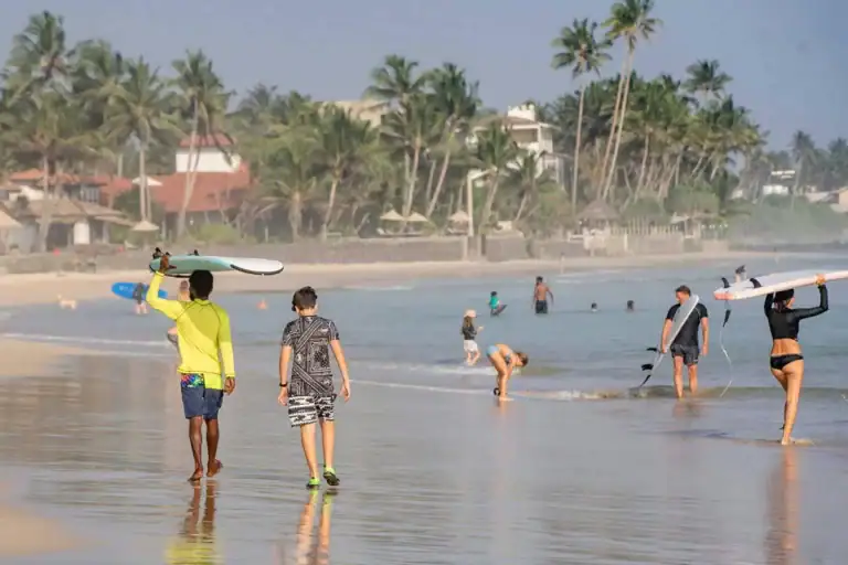 Foreign travellers enjoying a beach swim on Sri Lanka’s southern coast.