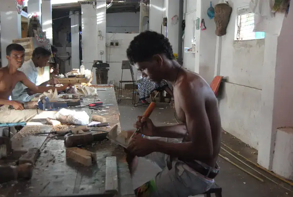 Carving the design of a mask - traditional masks in Sri Lanka