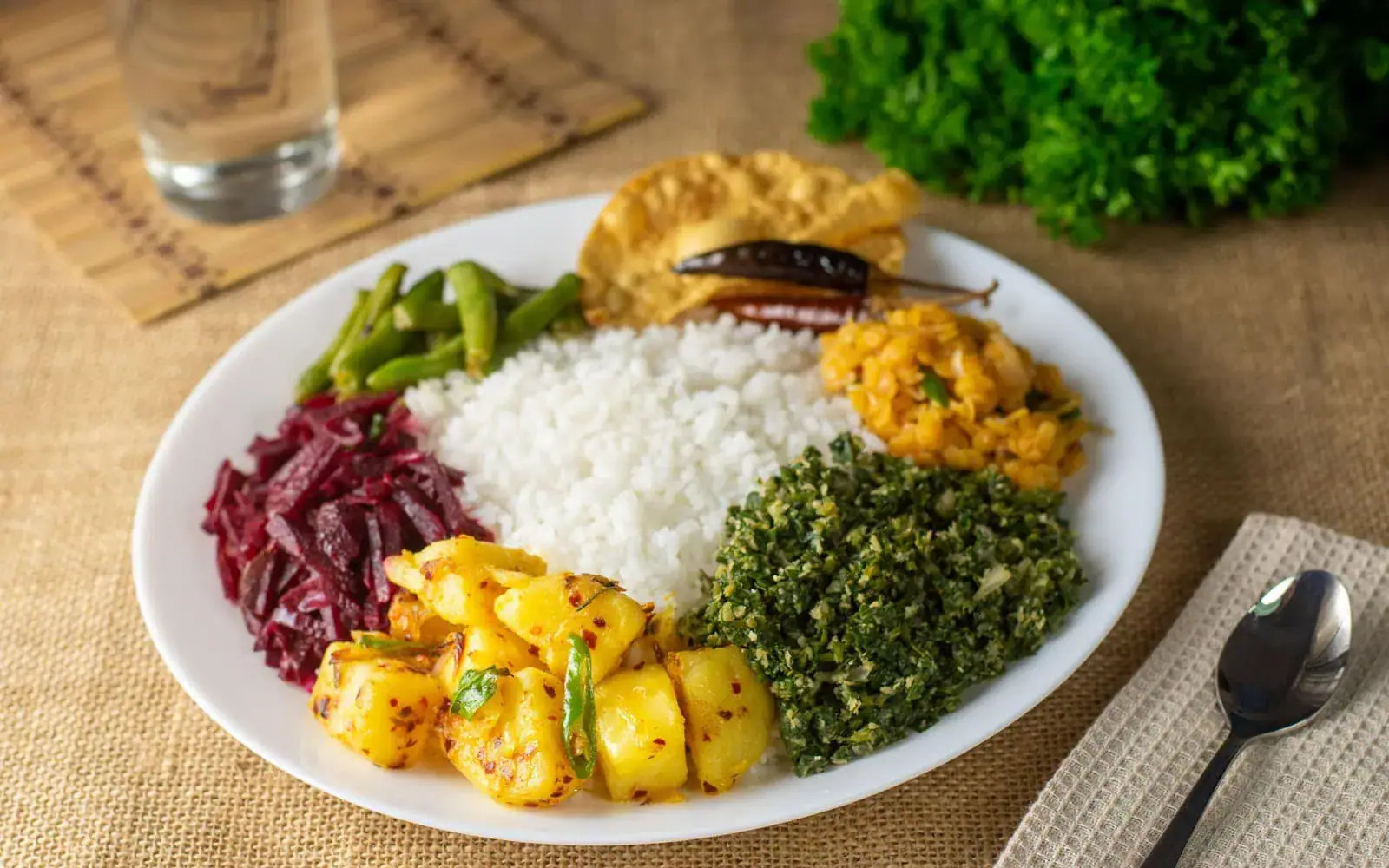 A traditional Sri Lankan rice and curry meal with several side dishes