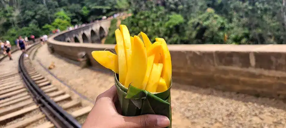 Having mango wrapped with a banana leaf